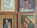 four framed pictures of a man holding a baby in a room
