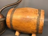 an old wooden barrel with a metal handle next to a pair of scissors