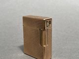 a gold lighter that is sitting on a table