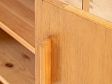 a close up of a wooden cabinet with a door open