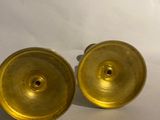 pair of brass plated candlesticks on a white background