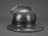 an old helmet is sitting on top of a gray surface