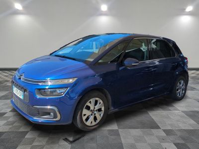 a blue citrole is parked in a room with a checkered floor