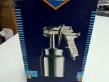 an empty box of a spray gun sitting on a table