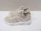 beige sneakers with white soles on a white surface
