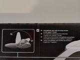 someone is holding a toothbrush in their hand in front of a box of toothpaste
