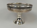 an image of a silver plate with a decorative design on it