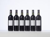 four bottles of wine are lined up on a table