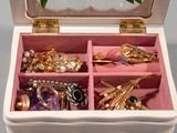 a white box with a bunch of jewelry inside of it
