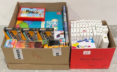 a box full of school supplies on the floor next to a red box