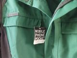 a green jacket with a black and white label on it
