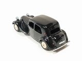 a black toy car that is sitting on a white surface