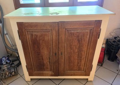 a cabinet with a sink and a window in the background