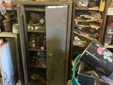 a dirty kitchen with a refrigerator and a trash can in it