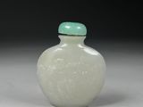 a white glass snuff bottle with a green lid