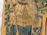 a tapestry hanging on the wall with a picture of a man
