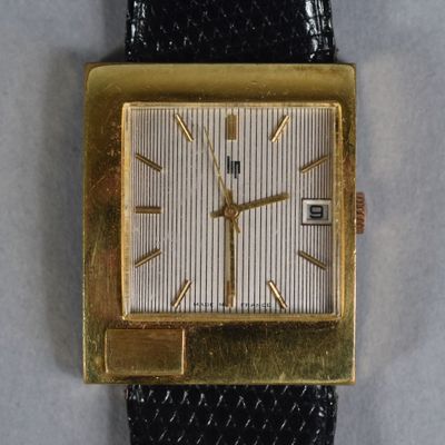 an image of a gold plated watch with a black leather strap