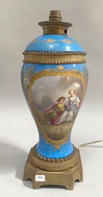 a blue and gold vase with a painting on it