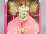 barbie doll in a pink dress with blonde hair in a pink box