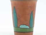 a brown cup with a blue and green design on it