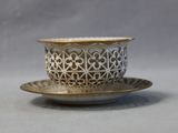 a cup and saucer on a saucer on a table