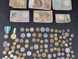an assortment of coins, medals, and medals are displayed on a table