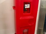 a red fire hydrant on the side of a wall