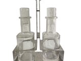 bottles and spoons are sitting on a wooden tray on a white background