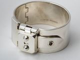 a close up of a silver bracelet with a lock on it