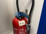 a fire extinguisor attached to the wall of a building