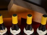 several bottles of wine are lined up in a row on a table