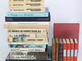 several books are stacked on top of each other on a table