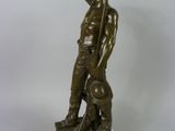 bronze statue of a man with a dog on a white background
