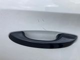 a close up of a door handle on a white car