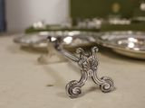 a small silver plate with a cross on it on a table