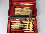 many knives in a red case with a yellow handle