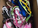 a cardboard box filled with lots of different colored leashes