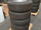 tires stacked on pallets in a warehouse with pallets in the background