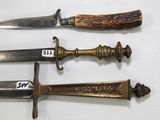 three different types of knives are displayed on a white surface