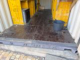 a container that has a door and a bucket on the floor