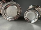 pair of silverplated salt and pepper shakers on a table
