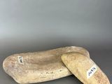 pair of wooden shoes with a tag on them sitting on a table