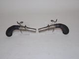 pair of silver and black revolvers on clear acrylic stand