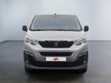 the front view of a silver van parked in a white room
