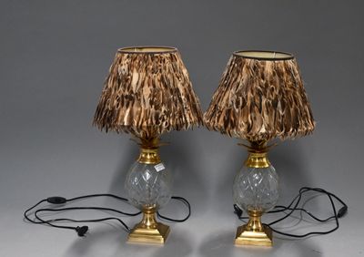 pair of lamps with straw lampshads on top of them