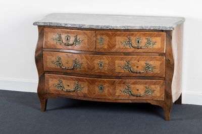 a marble top chest of drawers in the corner of a room