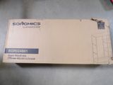 a box that is sitting on the floor next to a pair of scissors