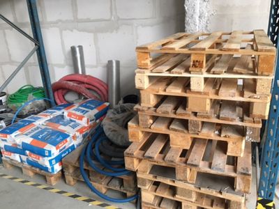 a stack of pallets sitting next to a pile of other pallets