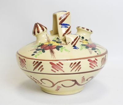 a vase with a design on it sitting on a table