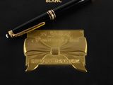montblanc fountain pen and business card on a black surface